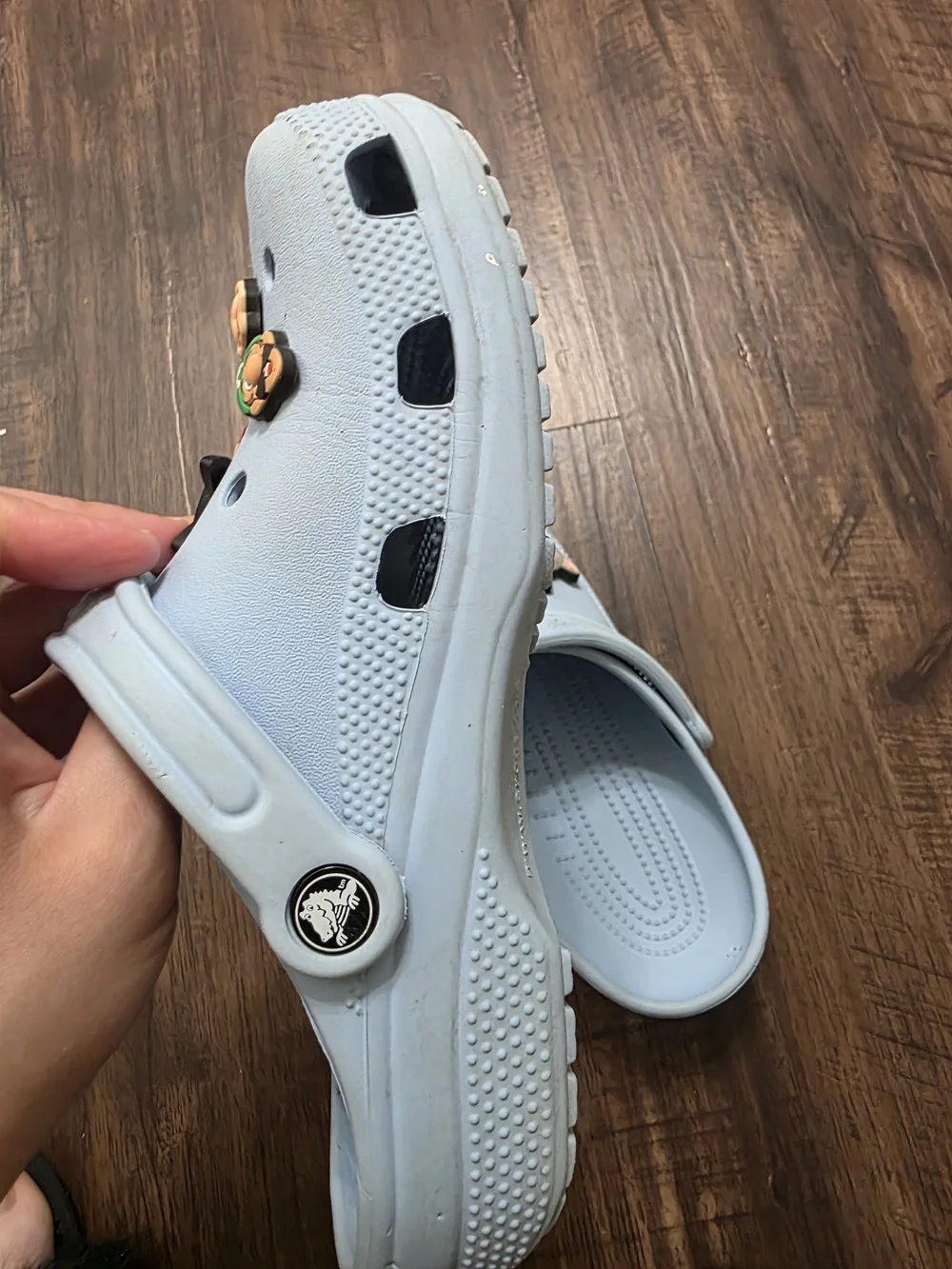 Crocs Classic Clog in a light blue color, size M6 / W8. Includes assorted decora